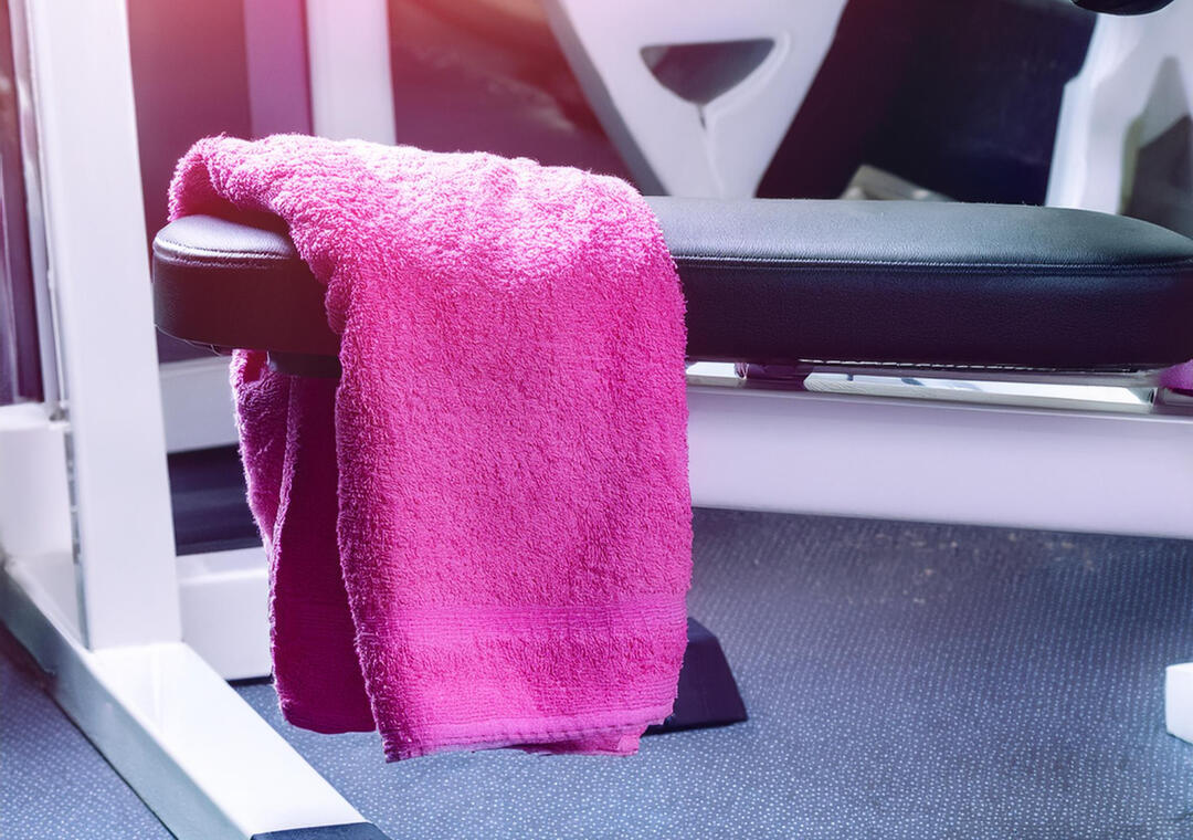 Small pink towel over the edge of a leg press machine at a gym